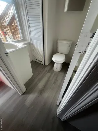 a bathroom with a toilet and bathtub