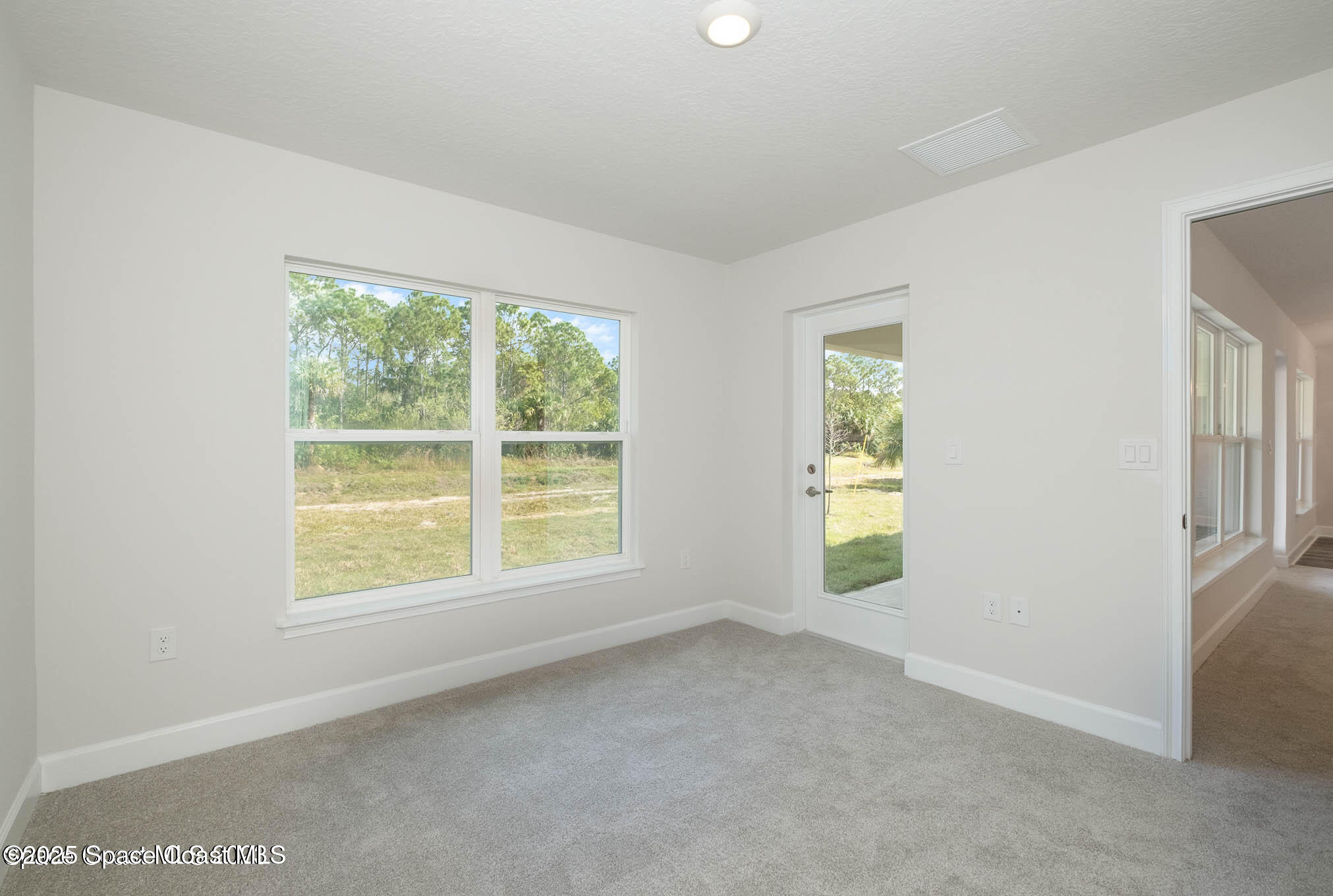 517 Winer Avenue Southwest Palm Bay, FL 32908 - Photo 5 of 15 an empty room with windows