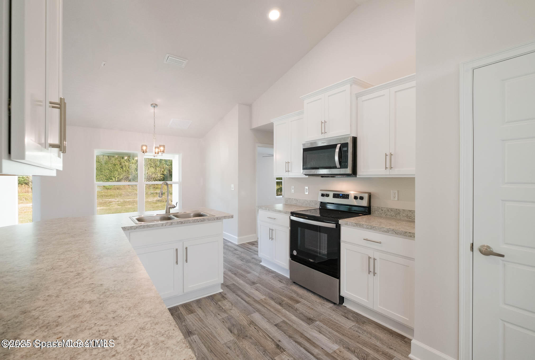 517 Winer Avenue Southwest Palm Bay, FL 32908 - Photo 9 of 15 a large kitchen with a stove top oven