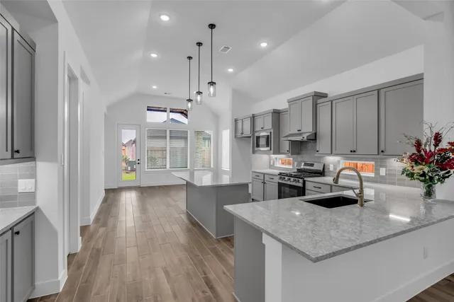 a kitchen with a sink a counter space and stainless steel appliances