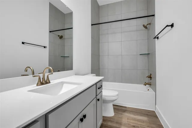 a bathroom with a sink toilet tub and shower