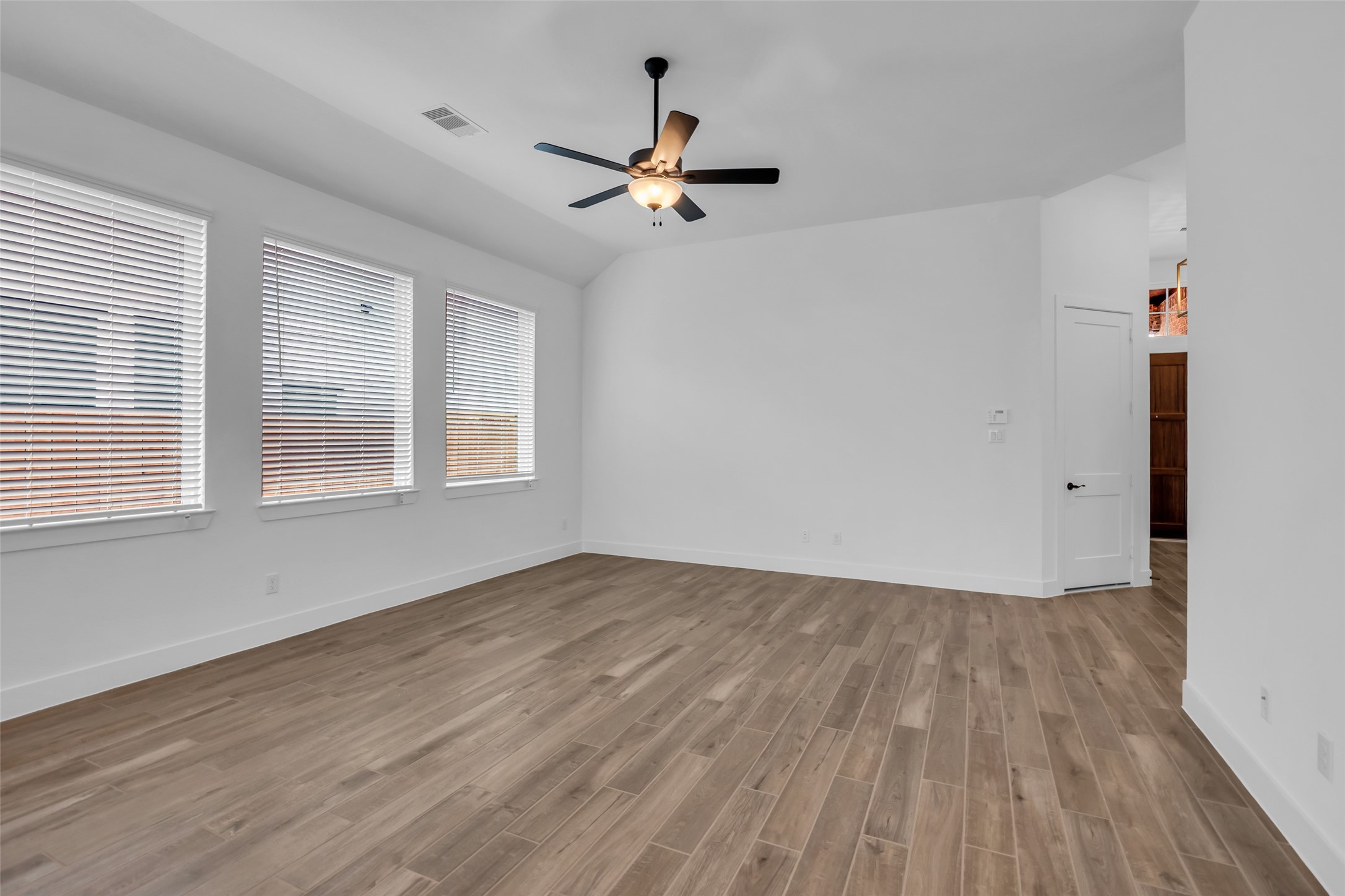 143 Afton June Drive Rosenberg, TX 77471 - Photo 10 of 25 a view of an empty room with wooden floor and a window