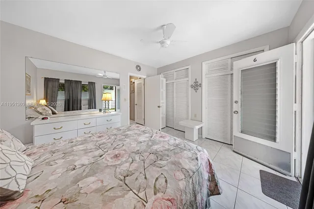 a spacious bedroom with a large bed and a dresser