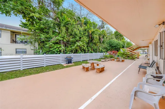 a view of a swimming pool with a patio and garden