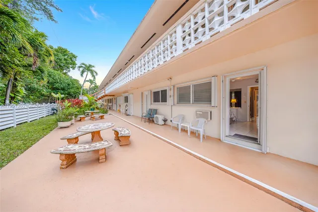 a swimming pool with outdoor seating and yard