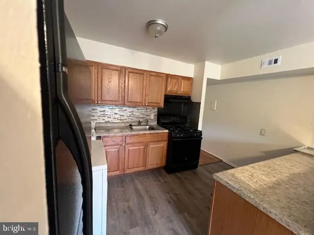a kitchen with a refrigerator and a stove