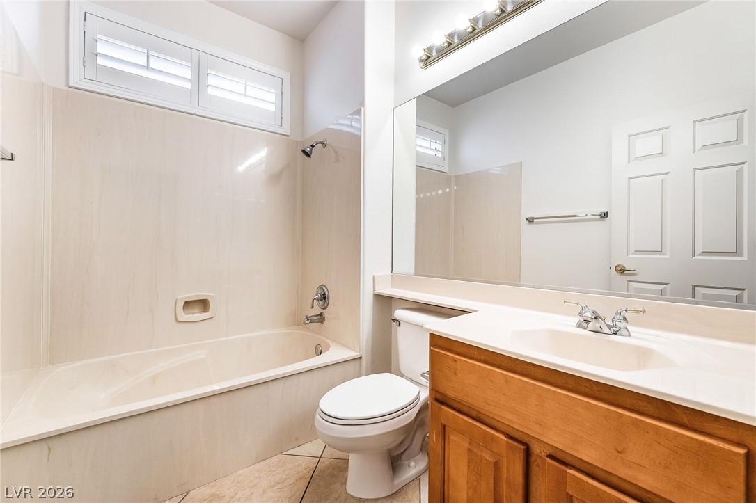 3033 Hartsville Road Henderson, NV 89052 - Photo 34 of 41 A well-lit bathroom features a functional bathtub, a practical toilet, and a vanity with ample counter space.