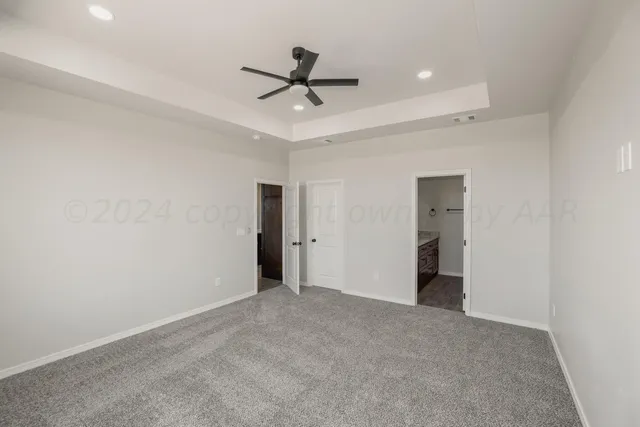 a view of an empty room with a ceiling fan