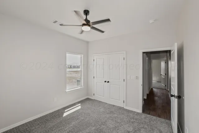 a view of a livingroom with a ceiling fan and window