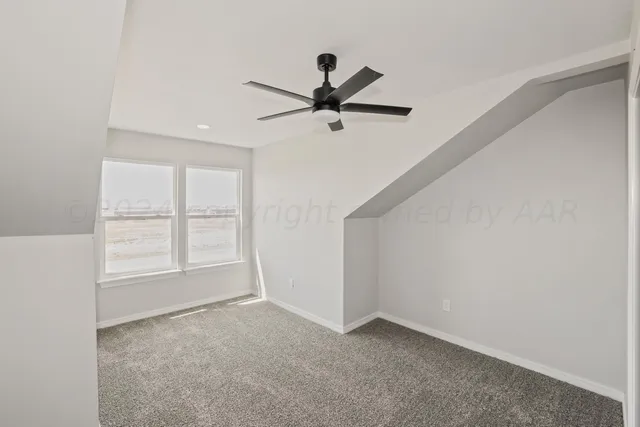 a view of a livingroom with a ceiling fan & entryway