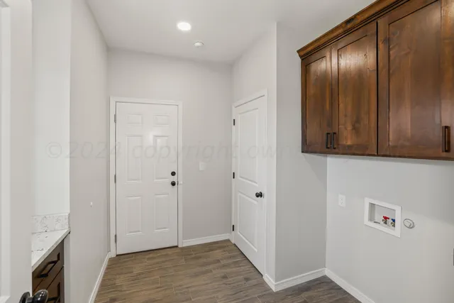 a view of a sink and dishwasher with wooden floor