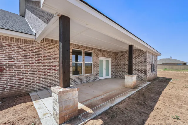 a view of a brick house with outdoor space