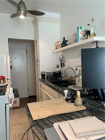 a kitchen with a stove a refrigerator and cabinets
