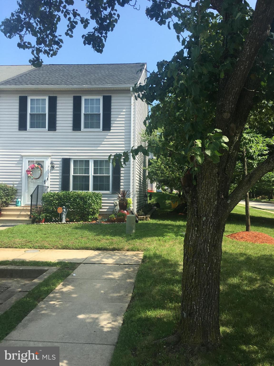 7110 Rutherford Green Circle Baltimore, MD 21244 - Photo 1 of 26 a front view of a house with a yard