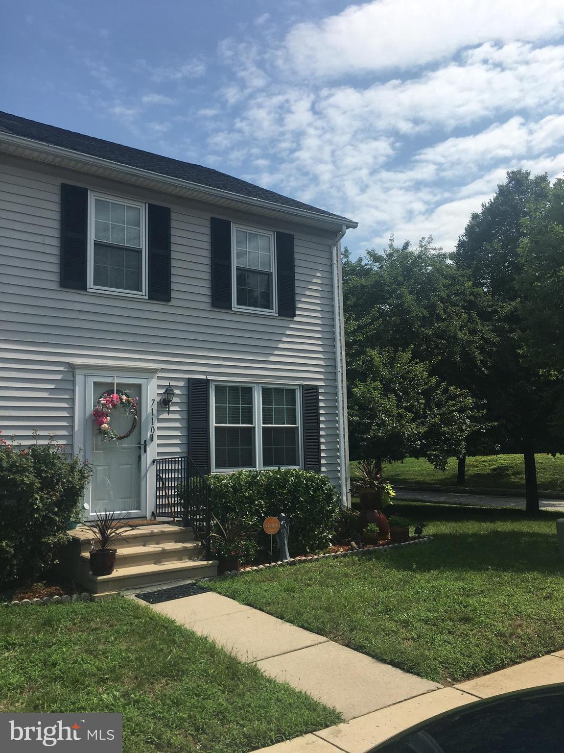 7110 Rutherford Green Circle Baltimore, MD 21244 - Photo 2 of 26 a front view of a house with a garden