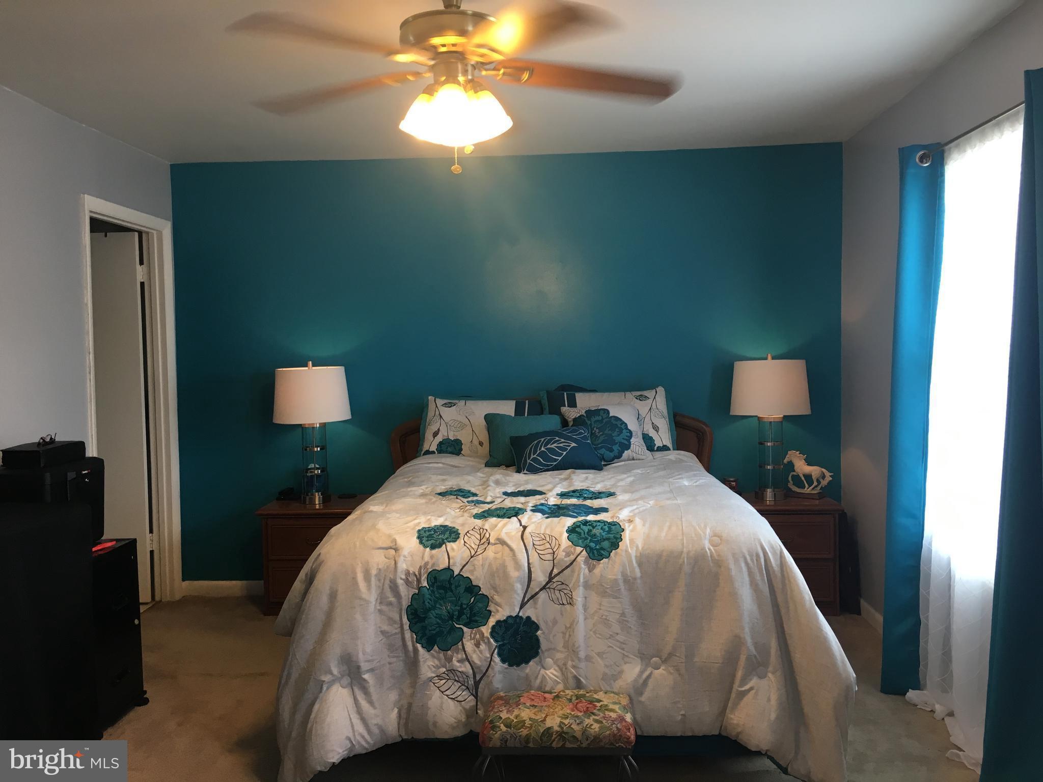 7110 Rutherford Green Circle Baltimore, MD 21244 - Photo 14 of 26 a bedroom with a bed and a chandelier