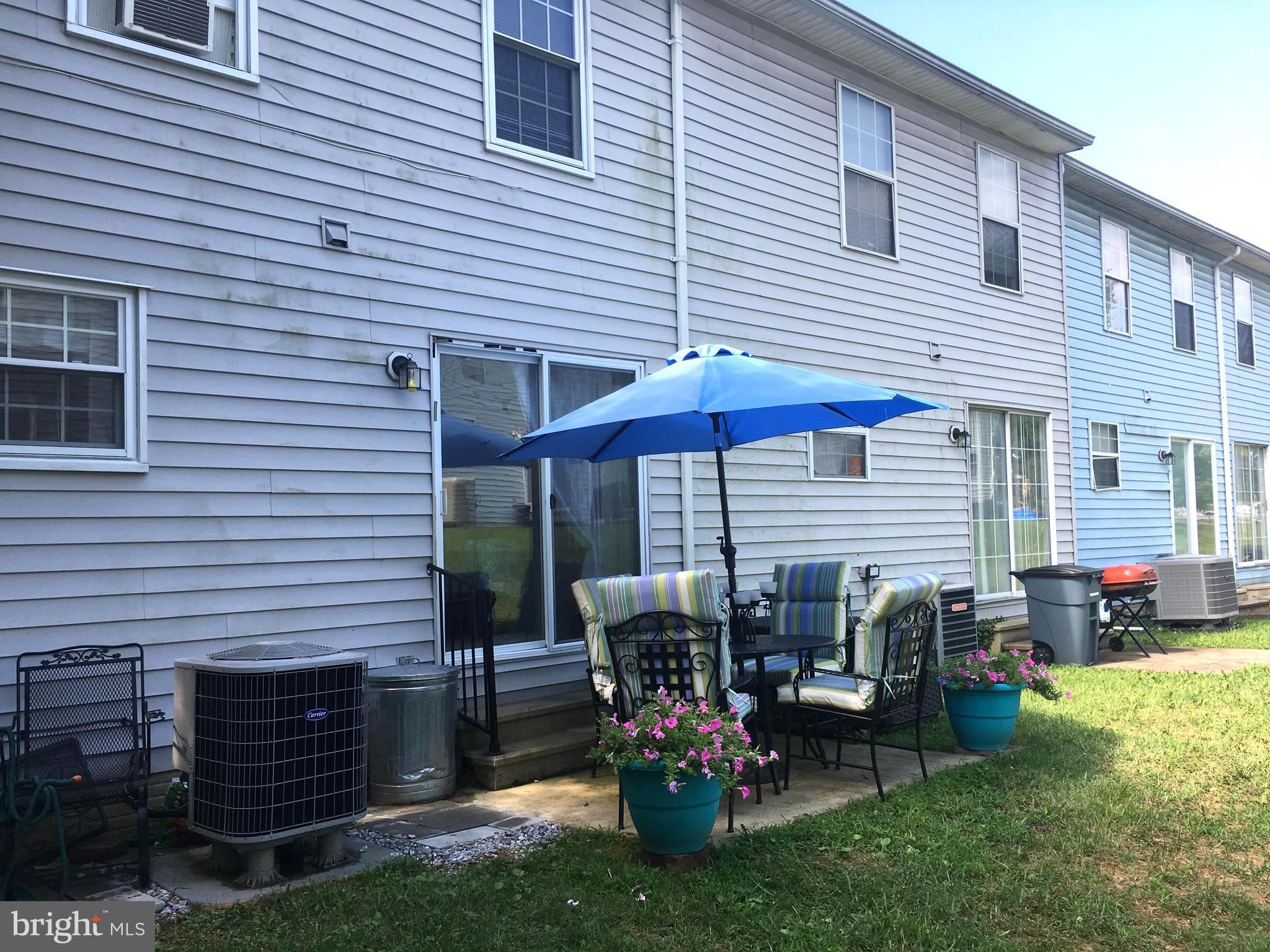 7110 Rutherford Green Circle Baltimore, MD 21244 - Photo 26 of 26 a table and chairs in front of the house