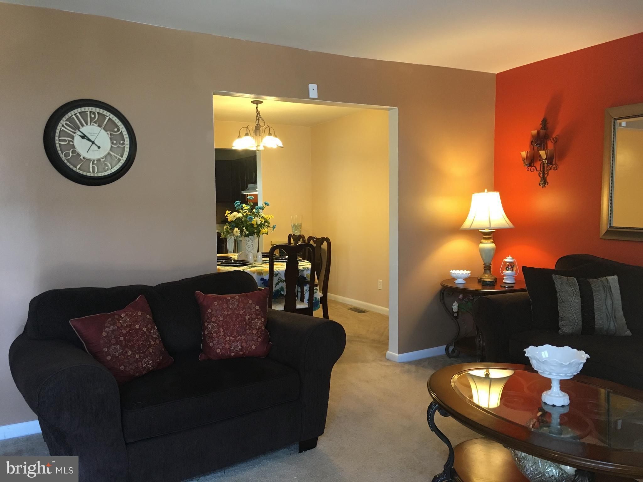 7110 Rutherford Green Circle Baltimore, MD 21244 - Photo 5 of 26 a living room with furniture and a table