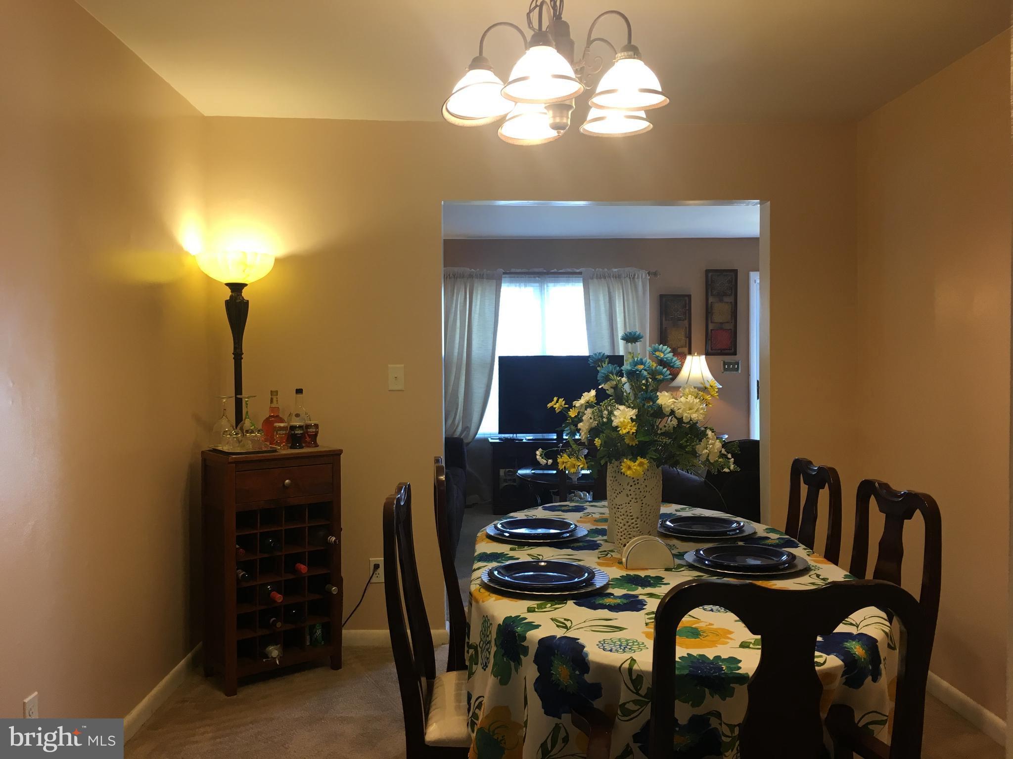 7110 Rutherford Green Circle Baltimore, MD 21244 - Photo 8 of 26 a view of a dining room with furniture and chandelier