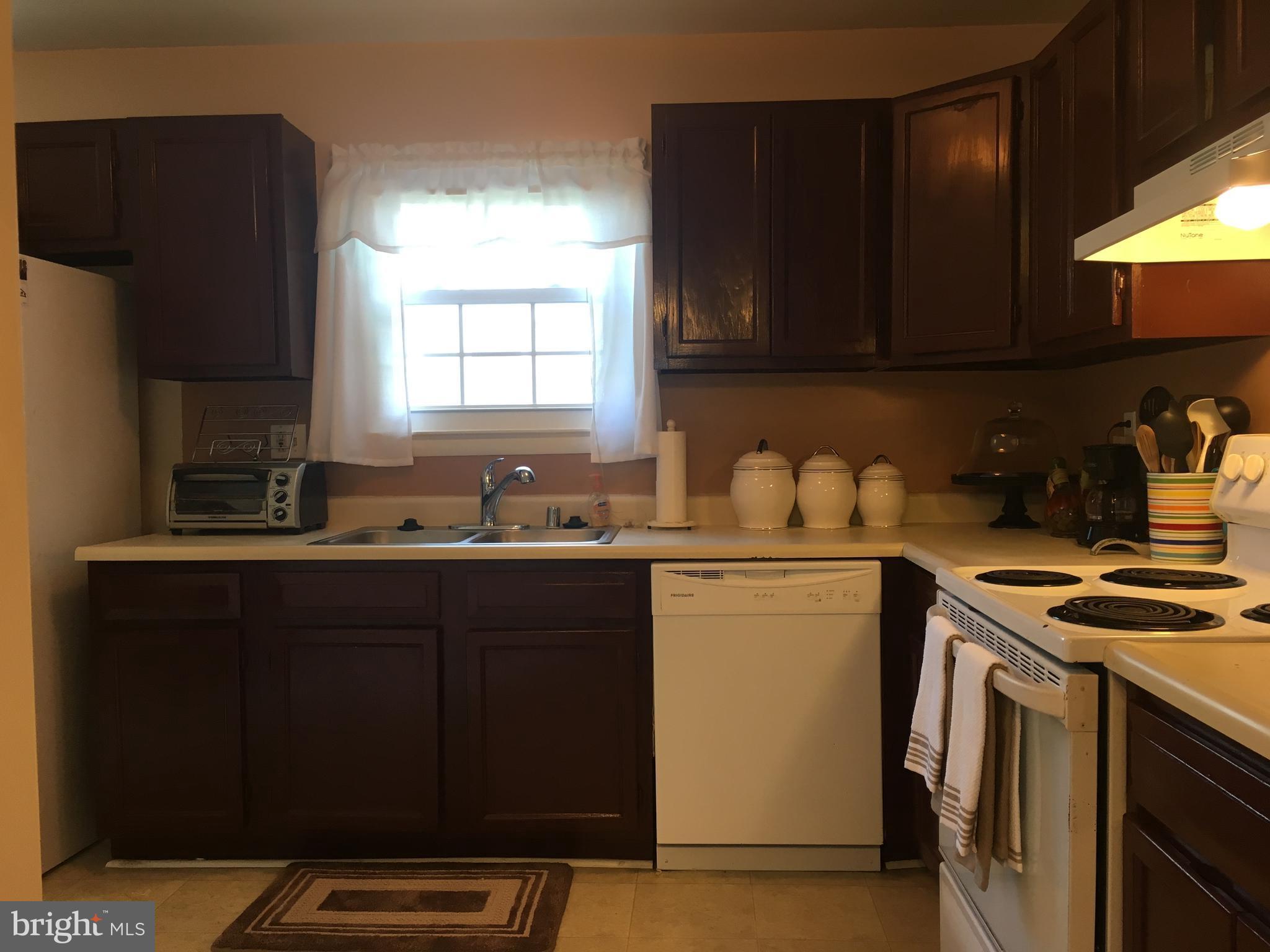 7110 Rutherford Green Circle Baltimore, MD 21244 - Photo 10 of 26 a kitchen with a sink a stove and refrigerator