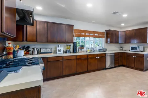 a kitchen with stainless steel appliances granite countertop a stove sink and cabinets