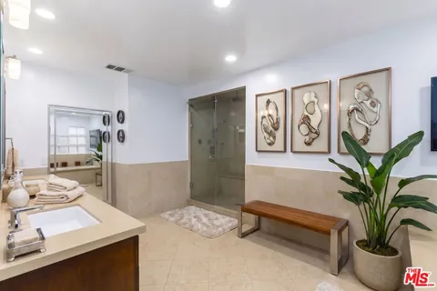 a living room with furniture and potted plant