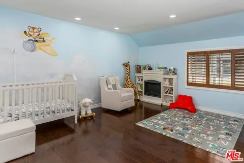 a bedroom with furniture and a fireplace