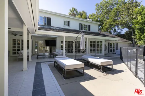 a swimming pool with outdoor seating and yard