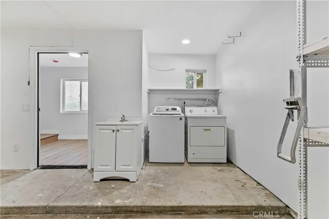 a view of an empty room with wooden floor and stairs