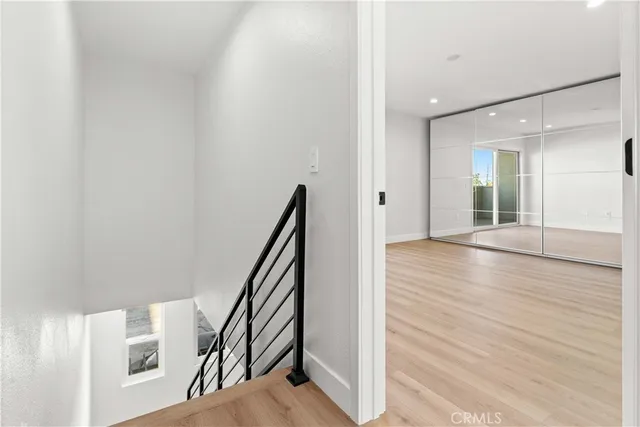 a view of empty room with wooden floor