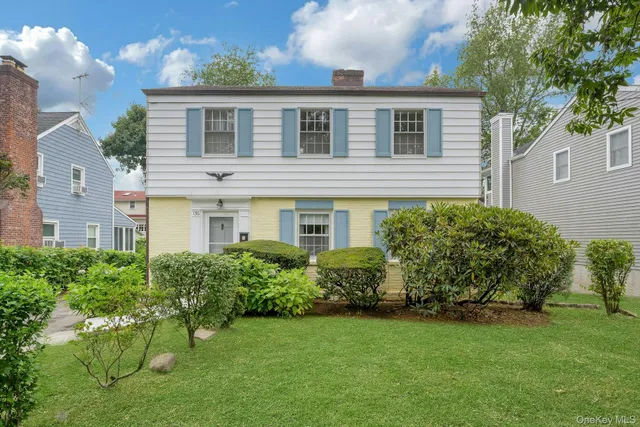 a front view of a house with a garden