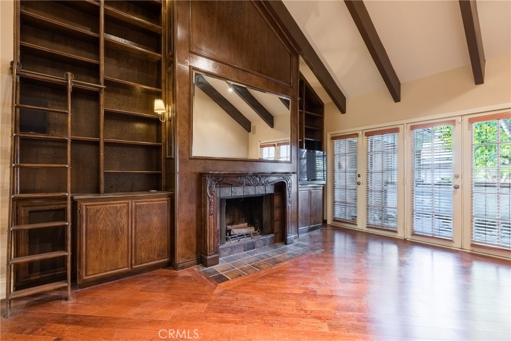 12386 Ridge Circle Los Angeles, CA 90049 - Photo 12 of 56 a view of an empty room with a fireplace and a window