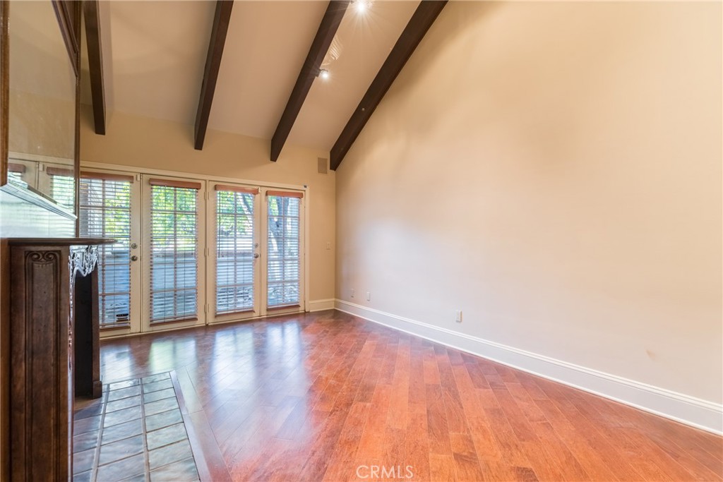 12386 Ridge Circle Los Angeles, CA 90049 - Photo 14 of 56 a view of an empty room with wooden floor and a window