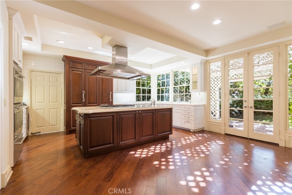 12386 Ridge Circle Los Angeles, CA 90049 - Photo 15 of 56 a open kitchen with a sink and dishwasher with a large window
