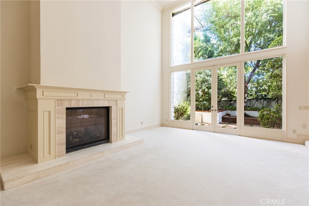 12386 Ridge Circle Los Angeles, CA 90049 - Photo 21 of 56 a view of an empty room with a window and a fireplace