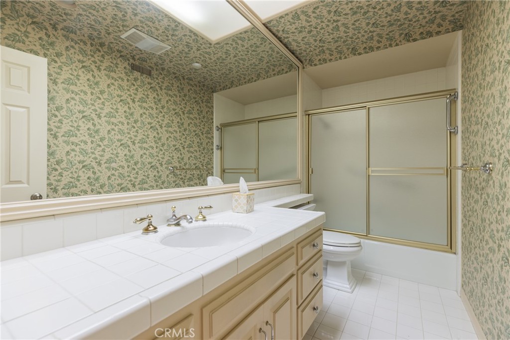 12386 Ridge Circle Los Angeles, CA 90049 - Photo 30 of 56 a bathroom with a sink and a mirror