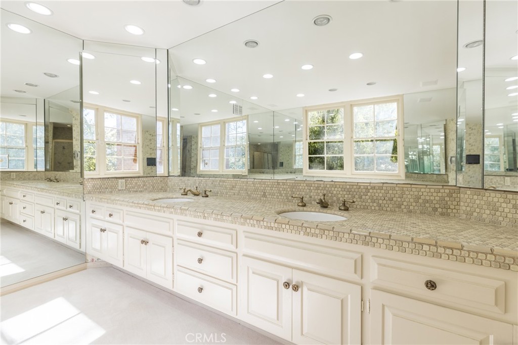 12386 Ridge Circle Los Angeles, CA 90049 - Photo 41 of 56 a bathroom with a granite countertop sink mirror and a