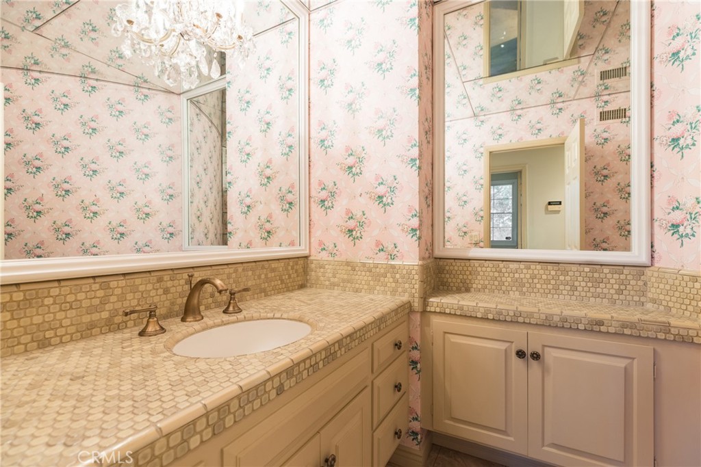 12386 Ridge Circle Los Angeles, CA 90049 - Photo 43 of 56 a bathroom with a granite countertop sink and a mirror