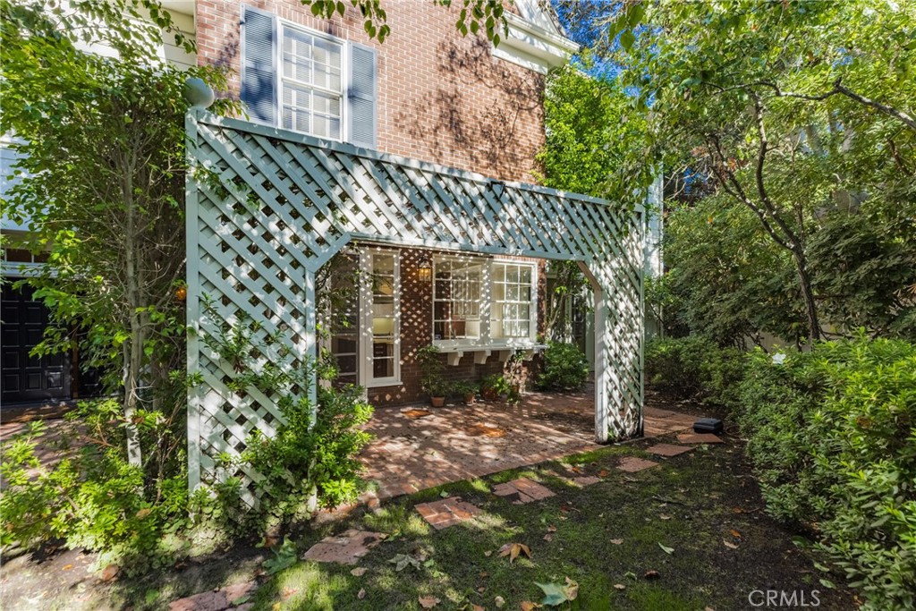 12386 Ridge Circle Los Angeles, CA 90049 - Photo 48 of 56 a front view of a house with a garden