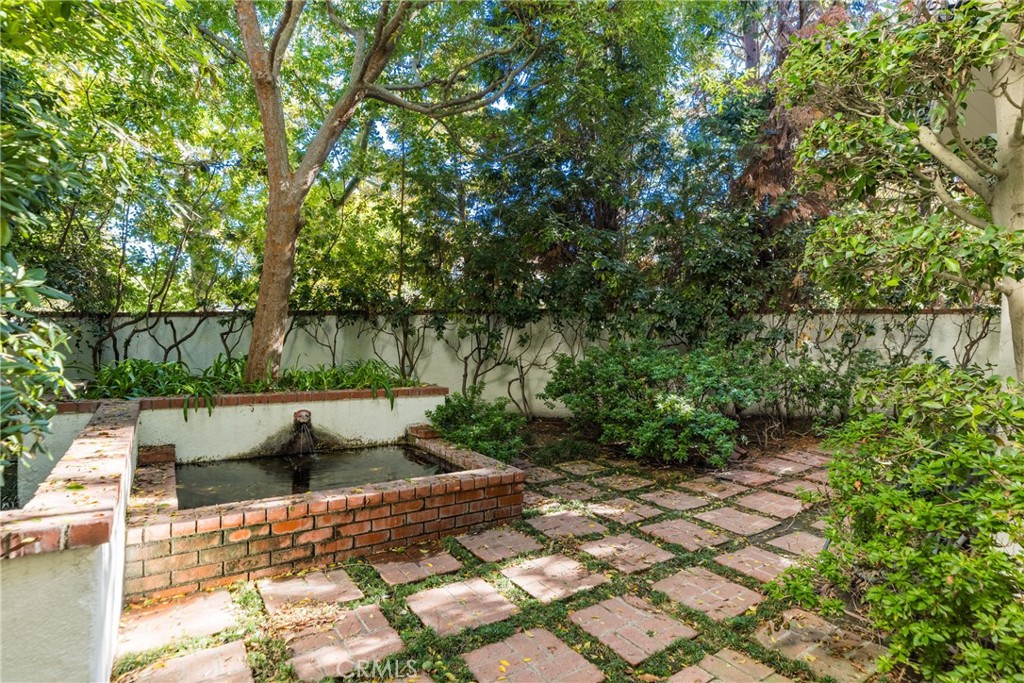 12386 Ridge Circle Los Angeles, CA 90049 - Photo 50 of 56 a view of a yard with plants and a barbeque