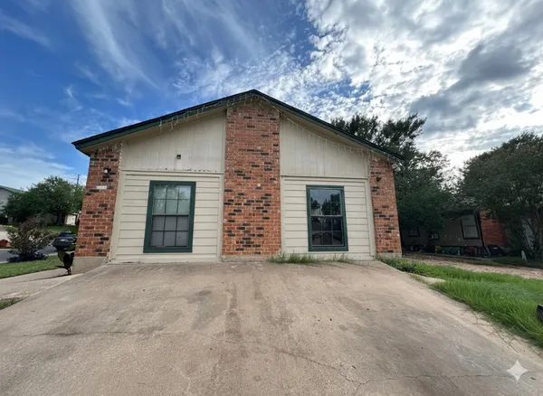 a front view of a house with yard and garage