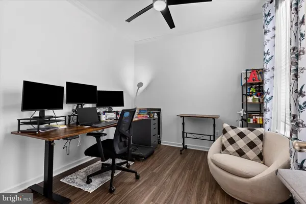 a view of a livingroom with workspace and a couch