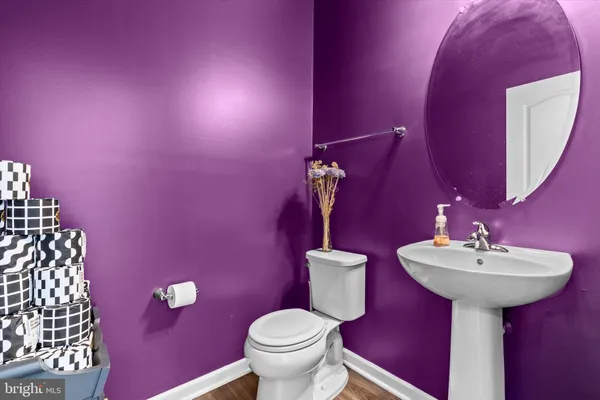 a bathroom with a sink mirror and toilet