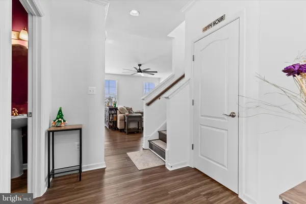a view of entryway and hall with wooden floor