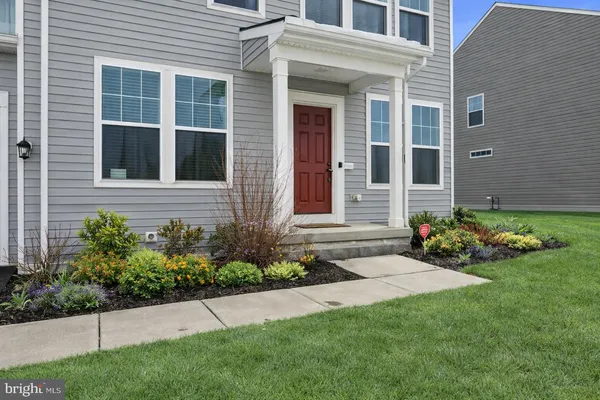 a view of a house with a garden and pathway