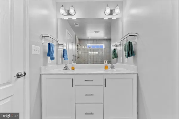 a bathroom with a sink vanity and mirror