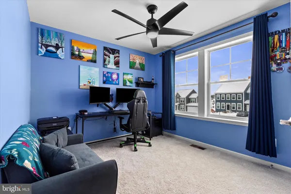 a view of a livingroom with workspace and a window