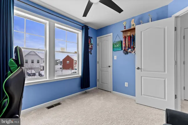 a view of a hallway with workspace and windows