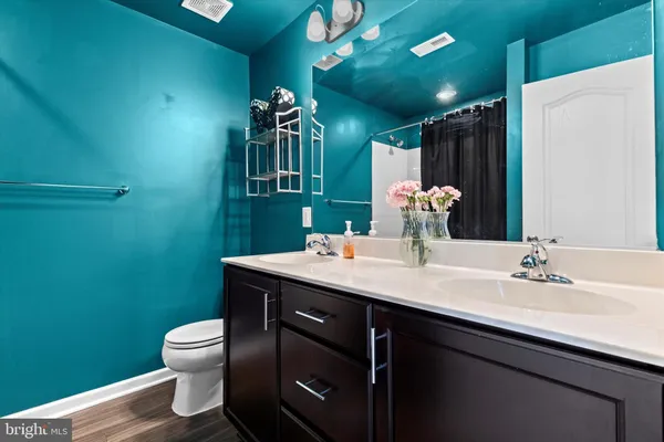a bathroom with a toilet sink and mirror