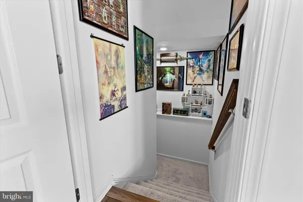 a view of hallway with furniture and a window